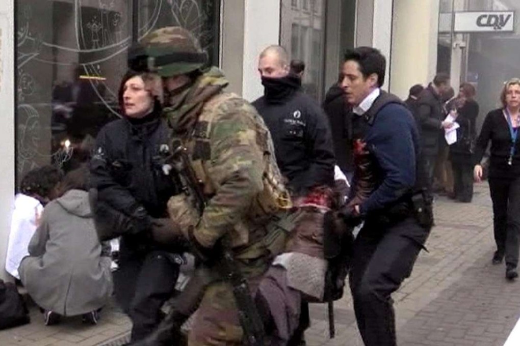 Belgian policemen and a soldier carrying an injured person after the March 22 terrorist attack on the Maelbeek Metro station in Brussels, Belgium. Photo: EPA