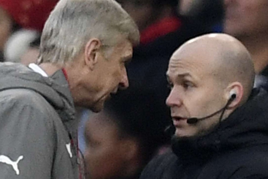 Arsenal manager Arsene Wenger clashes with fourth official Anthony Taylor before being sent to the stands. Photo: Reuters