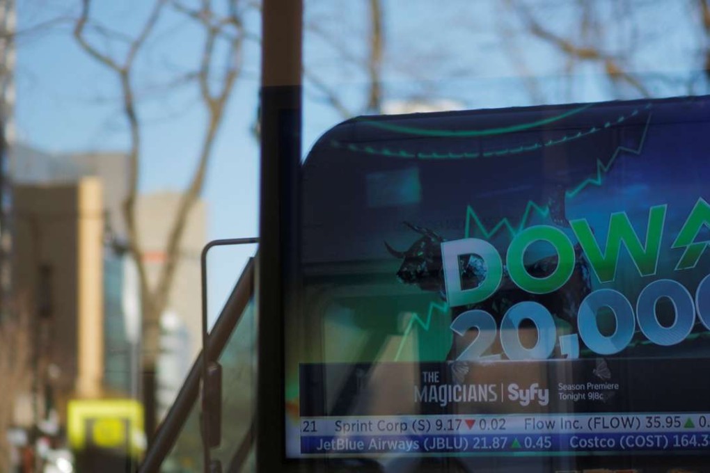 News of the Dow Jones Industrial average passing 20,000 plays on television at a Fidelity Investments office in Cambridge, Massachusetts. Photo: Reuters