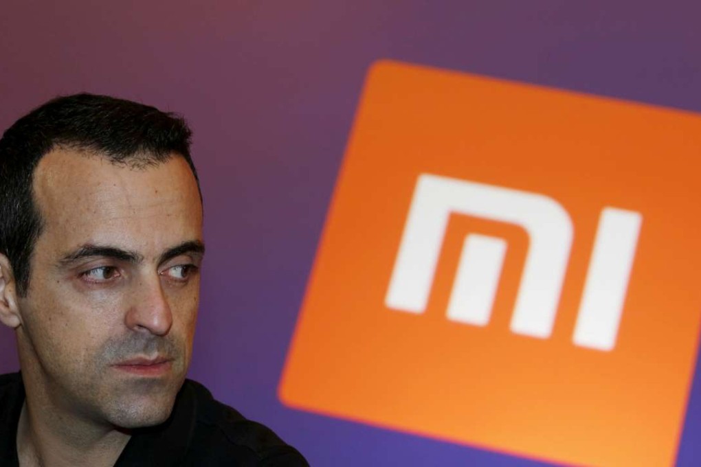 Xiaomi's Vice President Hugo Barra looks on in front of the company's logo during a group interview after the launching ceremony of Redmi Note 3 in Hong Kong. Photo: REUTERS/Bobby Yip/File Photo