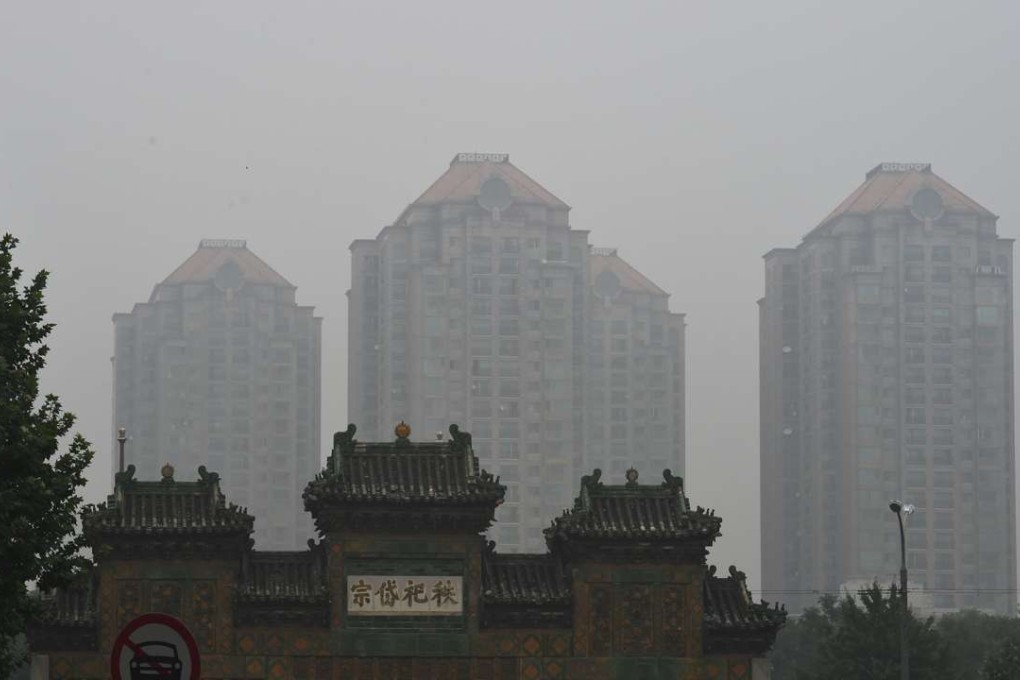 An old gateway contrasted against modern tower blocks in Beijing. Photo: AFP