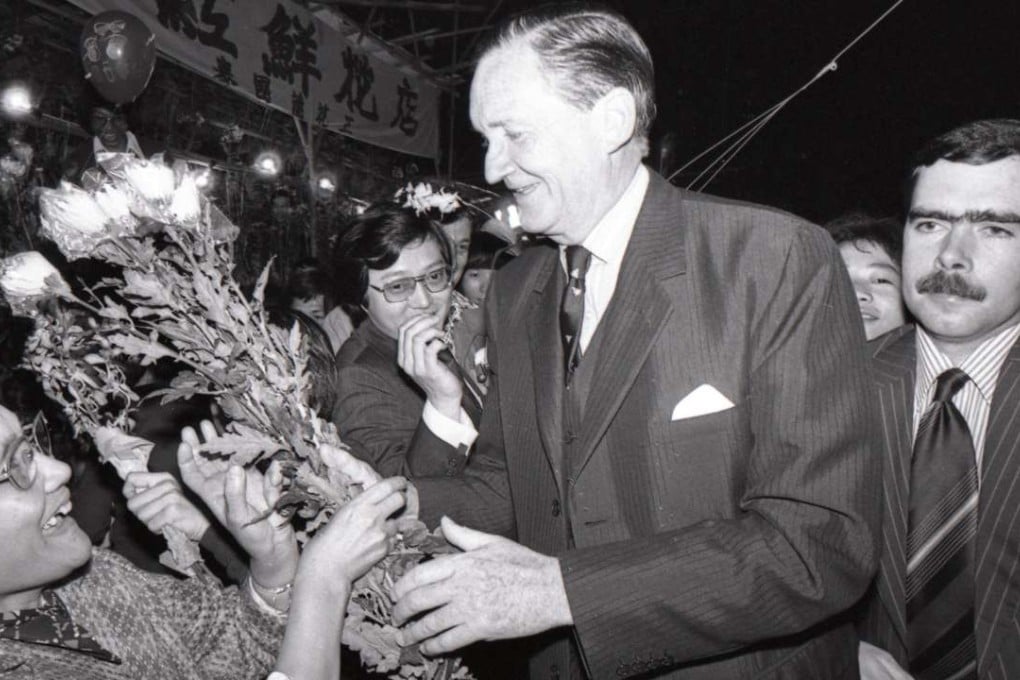 Governor Sir Murray MacLehose is presented with a bouquet during a visit to the Lunar New Year flower fair in Victoria Park on February 6, 1978. Pictures: SCMP