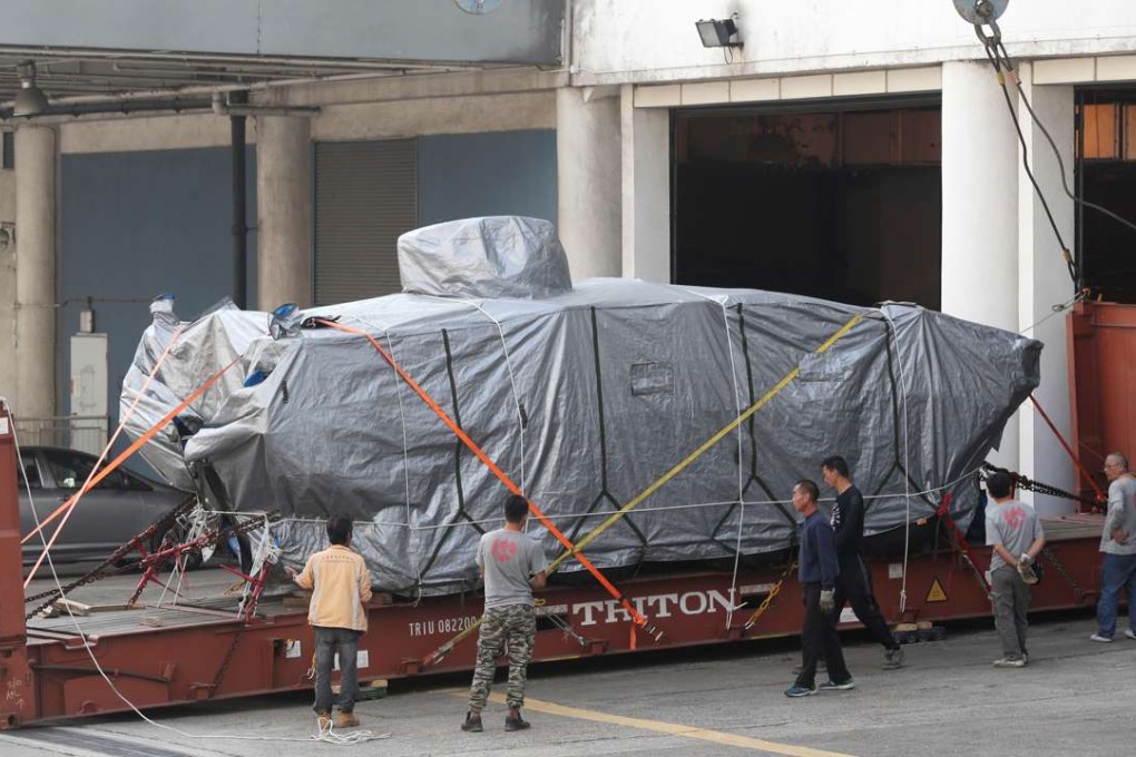 The first of the vehicles is moved out. Photos: Edward Wong
