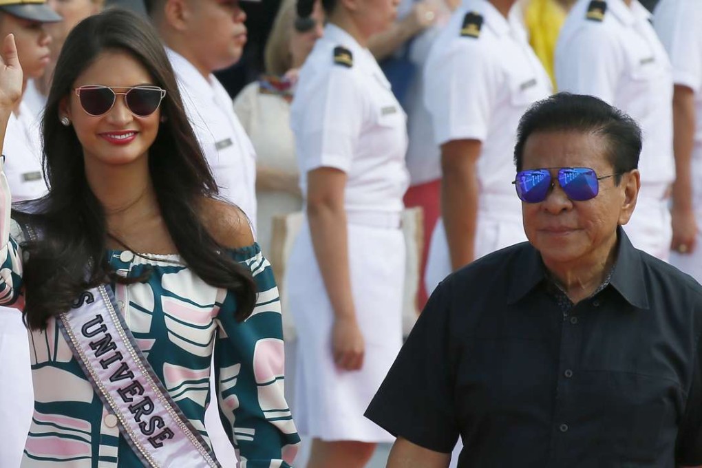 Miss Universe 2015 Pia Wurtzbach escorted by Luis Singson to a yacht to join contestants on a cruise to a beach resort in Batangas province, south of Manila on January 19, 2017. Photo: AP
