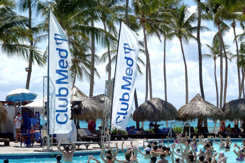 Club Med banners blow in the wind beside the swimming pool at the Club Med Punta Cana vacation resort in the Dominican Republic. Photo: Reuters