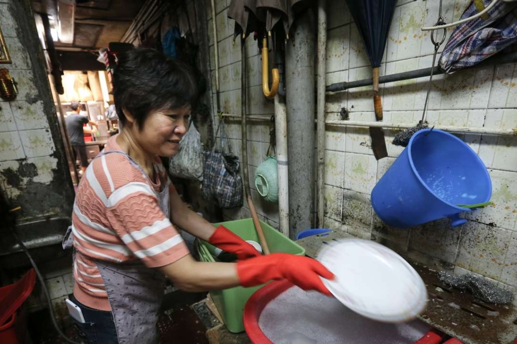 A worker washes dishes in a restaurant in Sham Shui Po. A government committee report recommends that working hours be standardised only for low-income employees. Photo: Dickson Lee