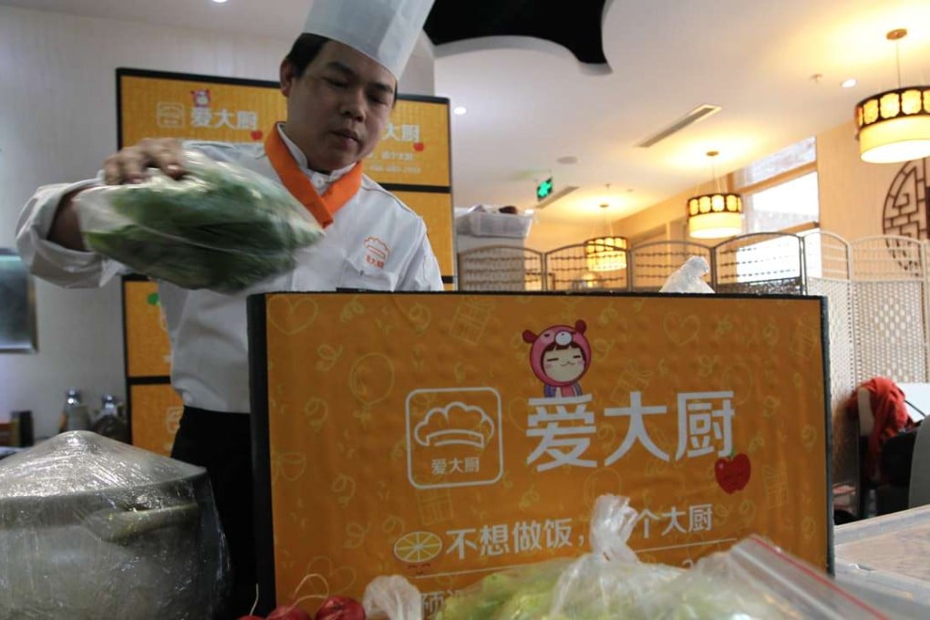 Qin Zhanwen, a chef for idachu, a Beijing-based mobile service to book chefs to cook at home, prepares the ingredients before heading out to a customer's home to cook. Photo: Simon Song