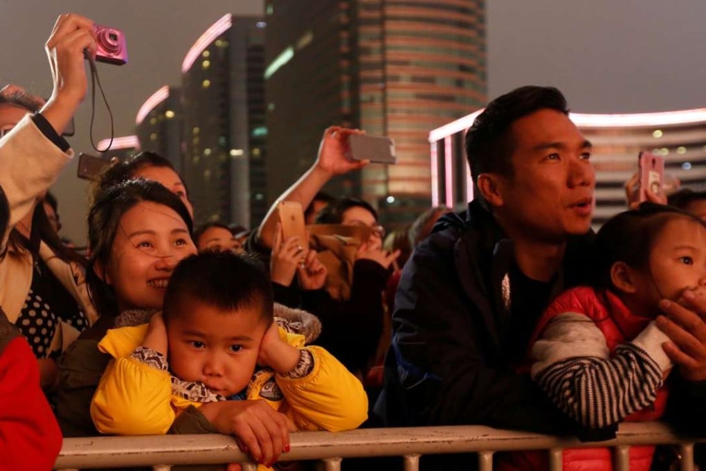Spectators watch fireworks explode over a cloudy Victoria Harbour during Lunar New Year celebrations in Hong Kong. Photo: Reuters