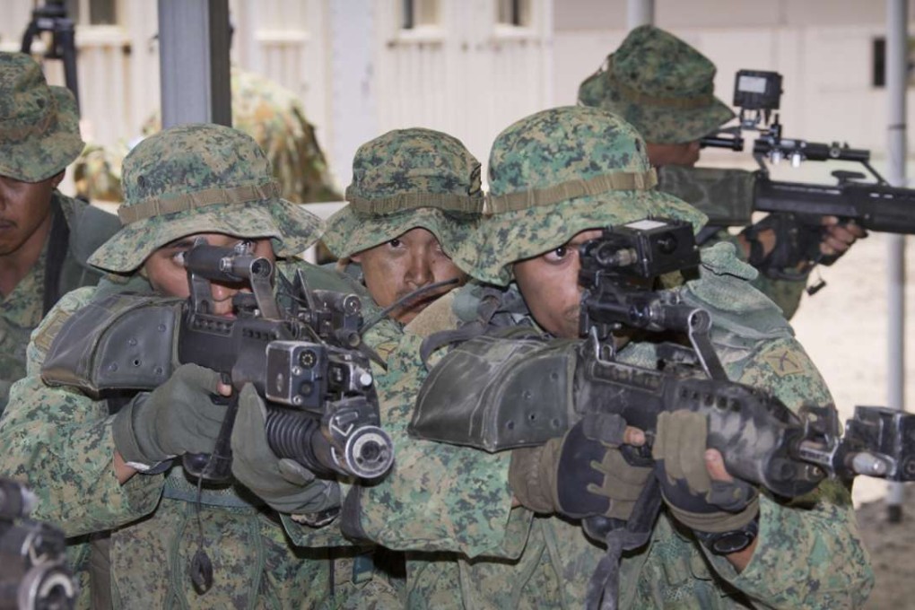 Singapore troops demonstrate urban assault techniques at the Shoalwater Bay training area, Queensland. Photo: DOD