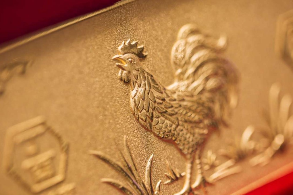 A gold bar featuring an image of a rooster on display inside a Chow Tai Fook store in Central. Photo: Bloomberg