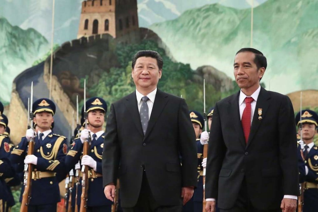 President Xi Jinping and his visiting Indonesian counterpart, Joko Widodo, view an honour guard during a welcoming ceremony at the Great Hall of the People in Beijing in March 2015. Photo: AFP