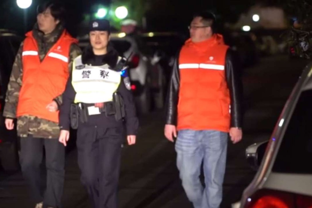 Police and volunteers carry out a patrol during the night of Lunar New Year’s Eve to impose the ban on the use of fireworks inside Shanghai’s Outer Ring Road. Photo: Thepaper.cn