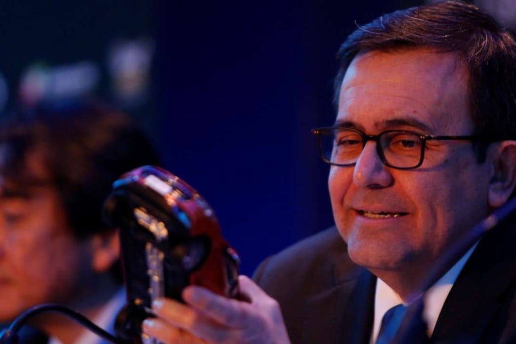 Mexico's Economy Minister Ildefonso Guajardo holds the model of a car during a news conference in Mexico City to announce a new plant for JAC Motors. Photo: Reuters