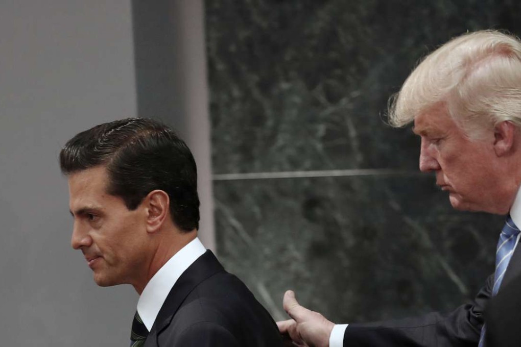 In this August 31, 2016 file photo, Republican presidential nominee Donald Trump walks with Mexico President Enrique Pena Nieto at the end of their joint appearance at Los Pinos, the presidential official residence, in Mexico City. Photo: AP