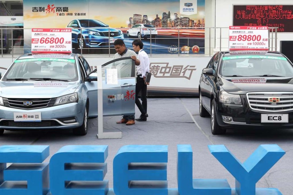 A Chinese visitor tries out Geely’s Emgrand car at an auto show in Nanjing. Photo Imaginechina