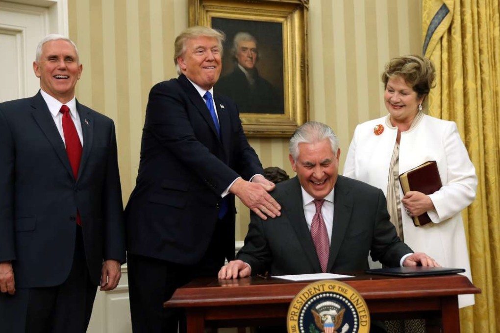 US President Donald Trump reacts during the swearing in ceremony for new US Secretary of State Rex Tillerson (second right) accompanied by his wife Renda St. Clair (right) and Vice President Mike Pence at the Oval Office of the White House in Washington. Photo: Reuters