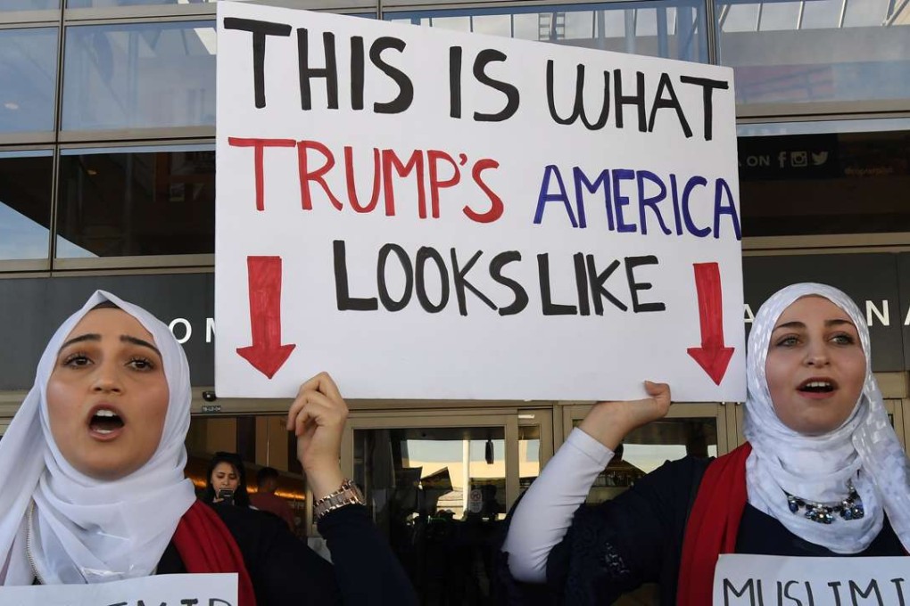 Noor Hindi (L) and Sham Najjar (R) who were born in the US of Syrian parents, demonstrate against the immigration ban imposed by President Trump at the Los Angeles International Airport. Photo: AFP