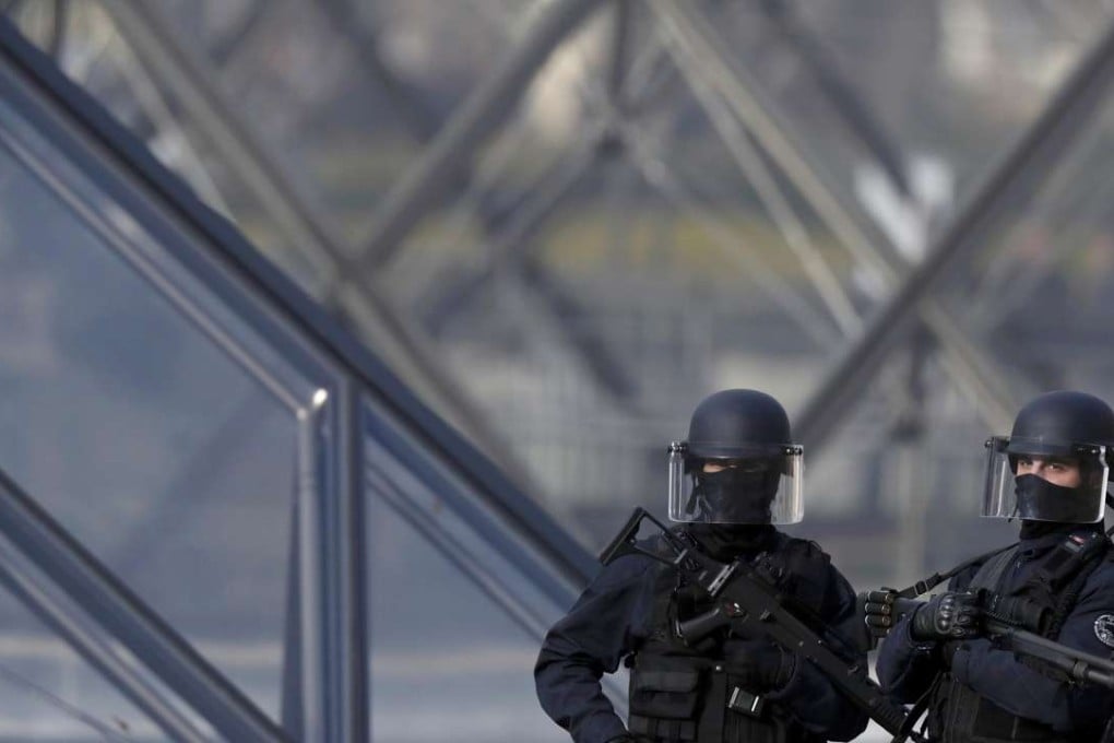 French police secure the site near the Louvre Pyramid in Paris, after a French soldier shot and wounded a man armed with a machete. Photo: Reuters