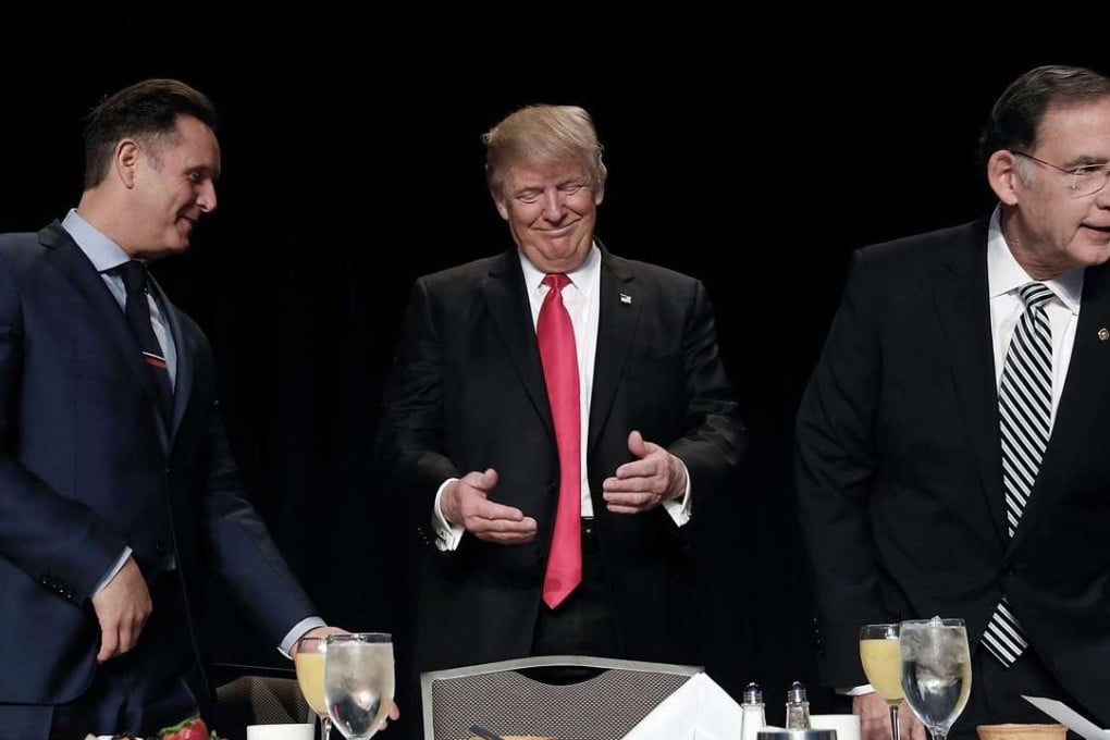 Television producer Mark Burnett (L), US President Donald J. Trump (L) and Senator John Boozman (R) during the National Prayer Breakfast in Washington, DC. Photo: EPA