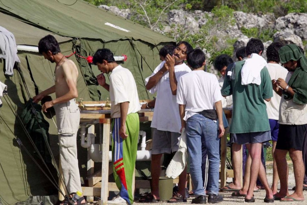 In this file photo, men shave, brush their teeth and prepare for the day at an Australian-run refugee camp on the Island of Nauru. In a deal struck with the Obama administration, Australia hopes to send about 1,200 such detainees to the US. Photo: AP