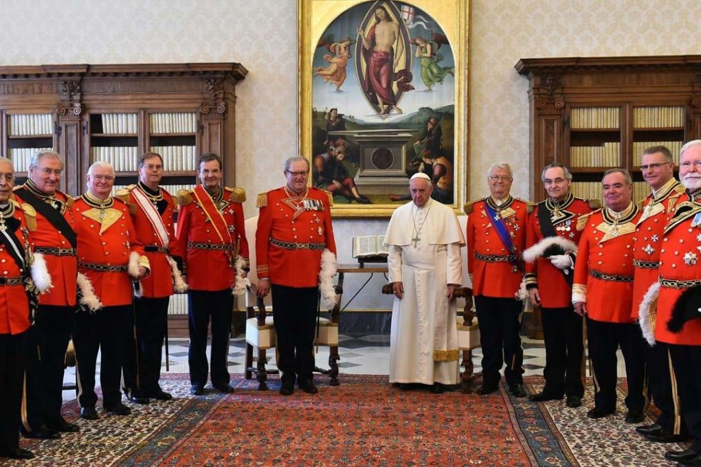 Pope Francis (centre right) stands with the now-ousted Grand Master of the Knights of Malta Matthew Festing (centre left), in a photo at the Vatican last June. Photo: AP