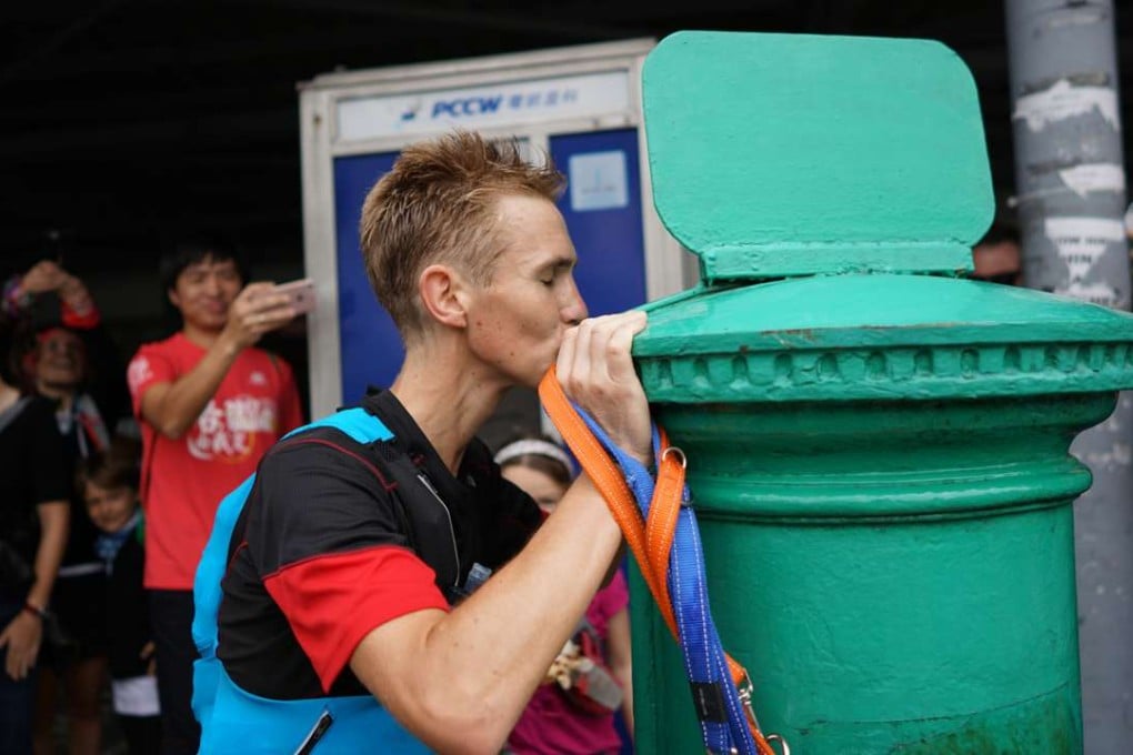 Tom Robertshaw kisses the finishing mark of the Hong Kong Four Trails Ultra Challenge. Photos: Lloyd Belcher