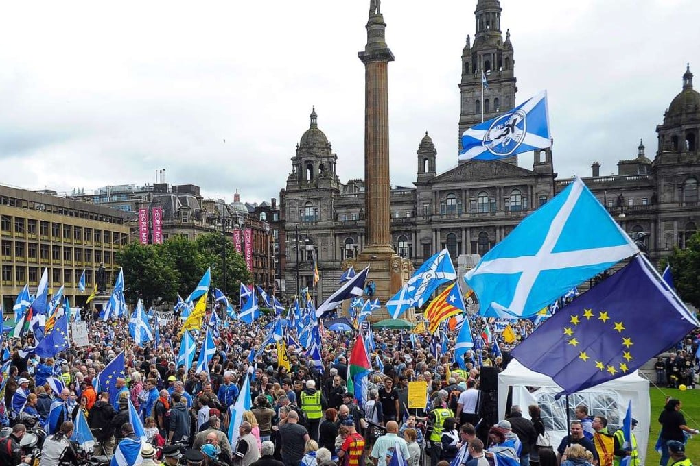 Pro-Scottish independence supporters rally in George Square in Glasgow, waving Scottish and EU flags, to call for a new bid for independence.Photo: AFP