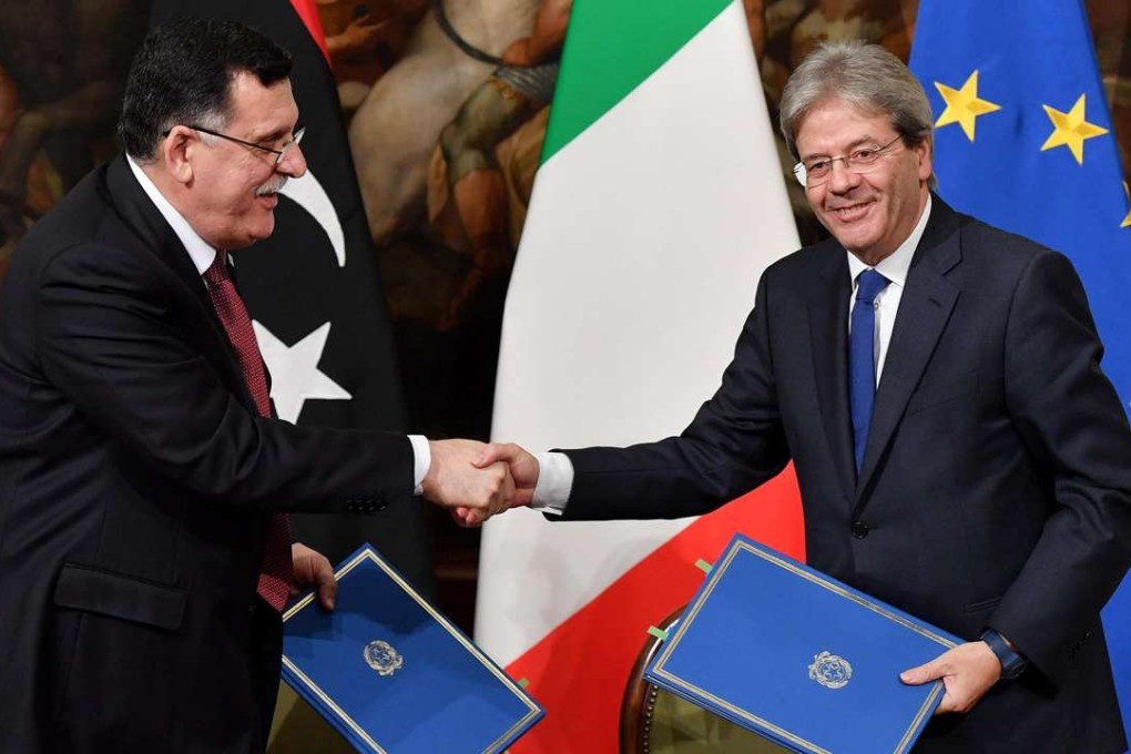 Italian Prime Minister Paolo Gentiloni, right, shakes hands with Prime Minister of Libya Fayez al-Sarraj during a joint press conference at Chigi palace in Rome. Photo: AP