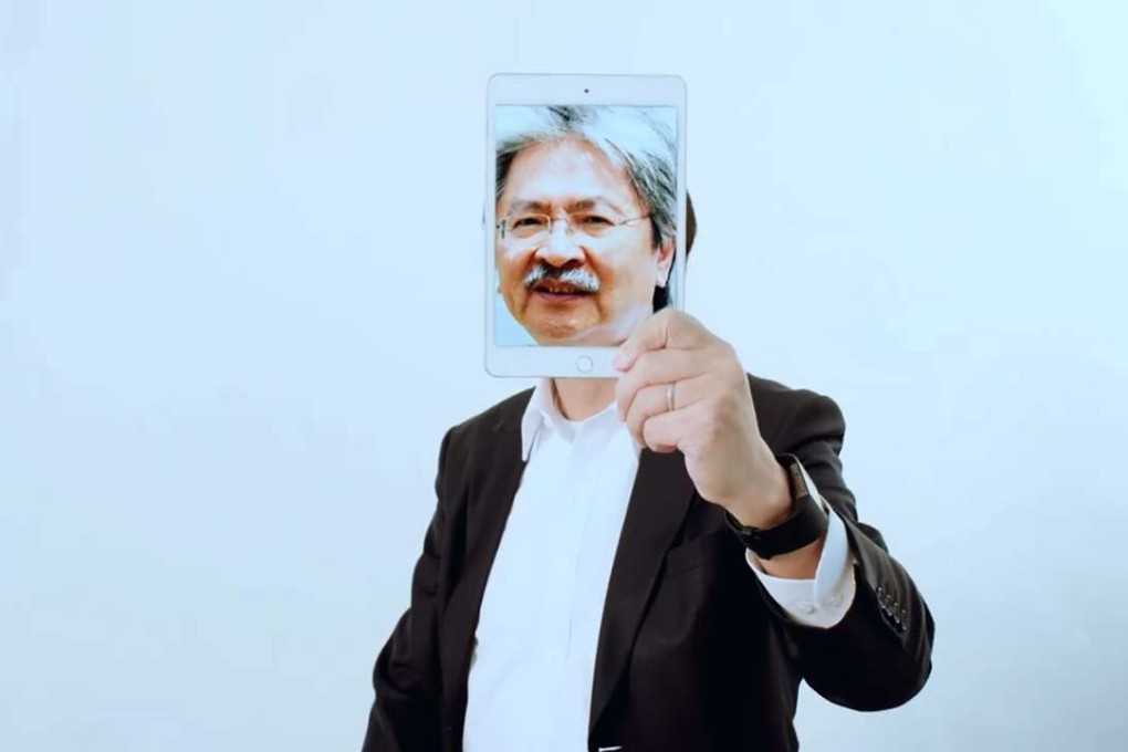 At the start of the video, Mak Chai-kwong held an image of former finance chief John Tsang in front of his own face. Photo: Facebook