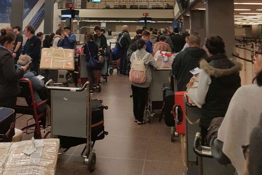 CX888 passengers at the Seattle airport waiting for their luggage. Photo: Handout