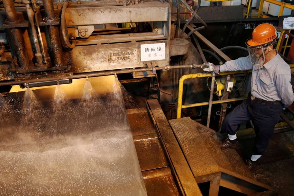 A worker inspects a roll of steel at a factory in Kaohsiung, southern Taiwan. Photo: Reuters