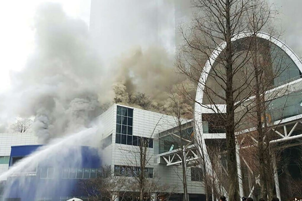 Rescue workers fight the fire that broke out at a shopping mall connected to a couple of residential skyscrapers in Dongtan. Photo: AFP