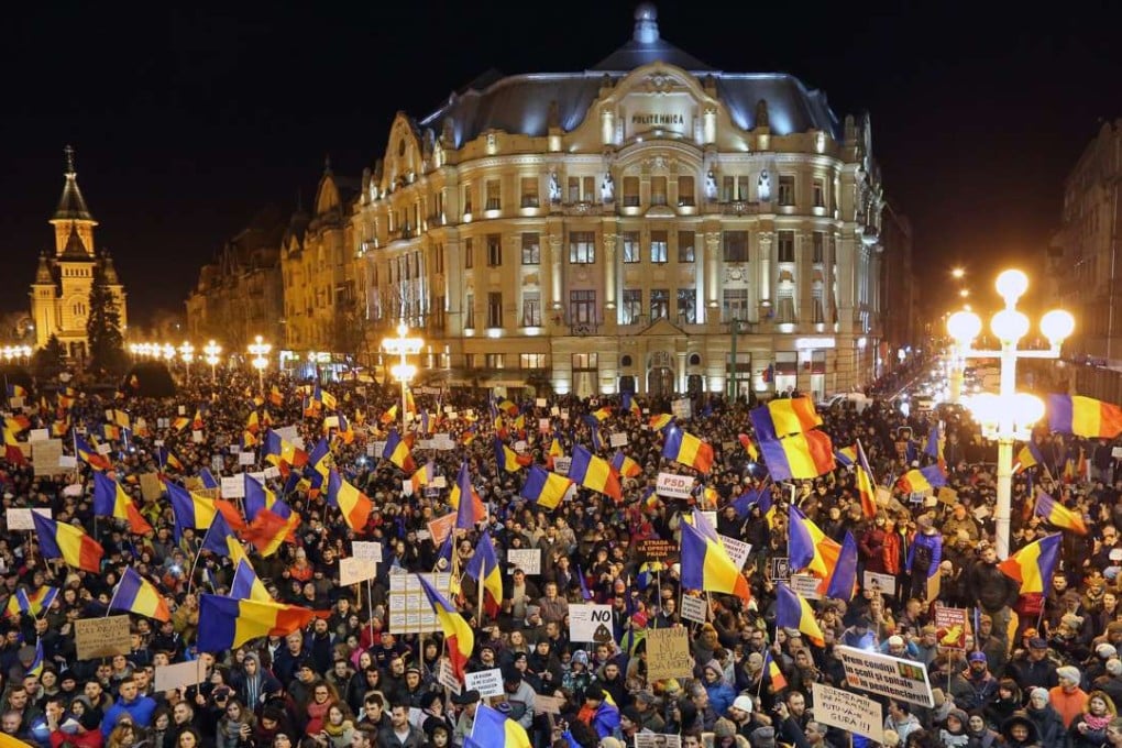 People shout anti-government slogans during a protest rally in Timisoara, Romania. Photo: EPA