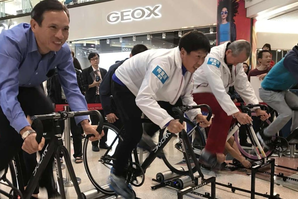 Cycling Association chairman Leung Hung-tak, Commissioner for Sports, Yeung Tak-keung and Karl Kwok Chi-leung, chairman of the Major Events Committee, match their skills on stationary bikes at Saturday’s press conference. Photo: Handout