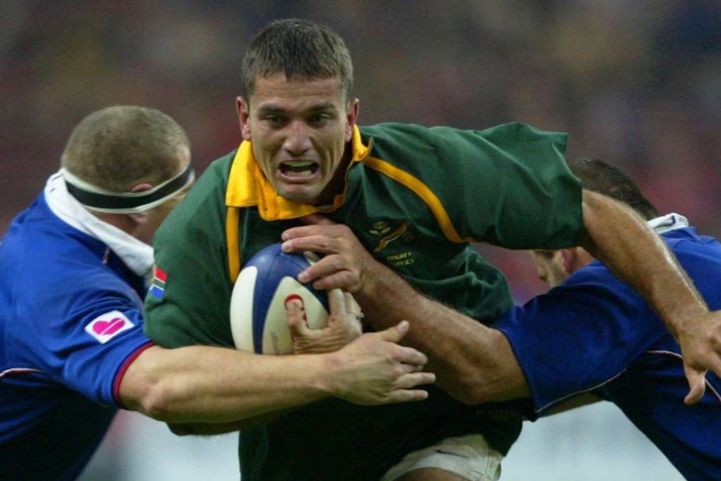 South African scrum-half Joost Van Der Westhuizen is tackled by French props Pieter De Villiers and Jean-Jacques Crenca during a rugby test match in 2001 at the Stade de France, Paris. Photo: AFP