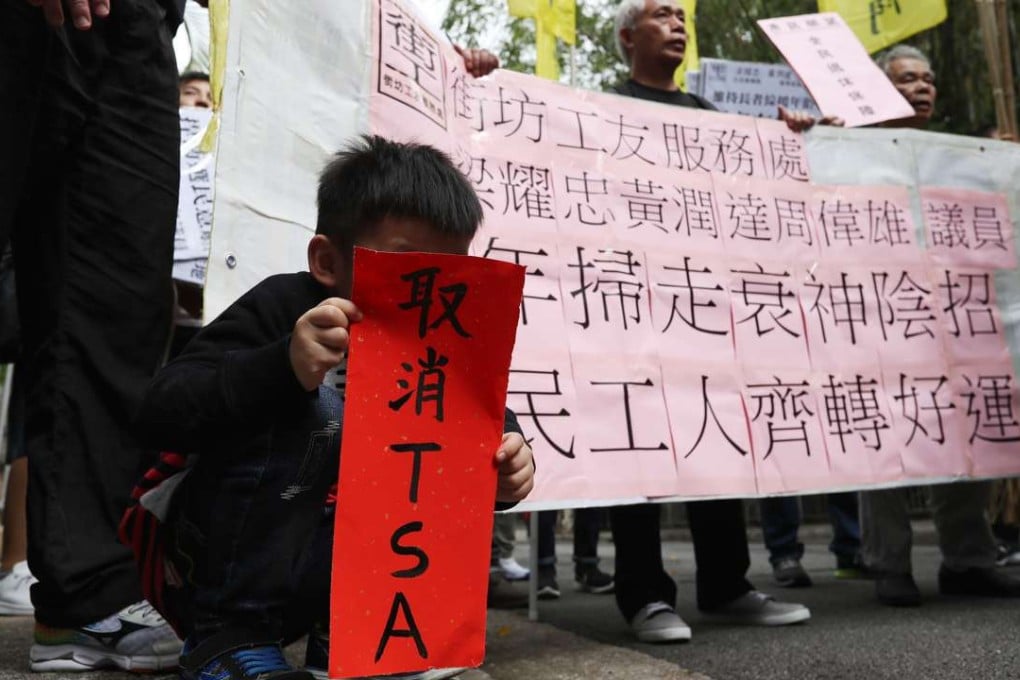 A young boy holds up a “fai chun” saying “cancel TSA”, at a protest against Chief Executive Leung Chun-ying’s performance, outside Government House on January 30. Photo: Nora Tam