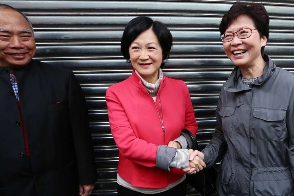 Regina Ip and Carrie Lam shake hands after running into each other following Lam’s meeting with Election Committee members from the agricultural and fisheries subsector in Aberdeen on January 30. Photo: Jonathan Wong