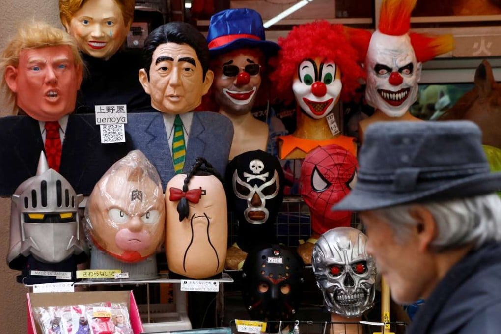 A man walks past a shop selling masks of US President Donald Trump and Japanese Prime Minister Shinzo Abe at a market street in Tokyo. Abe wants to push for abolition of Article 9 of Japan’s post-war constitution. Yet, even with his generally high approval rating domestically, it could prove a major challenge, given the large body of public opinion which still values its post-war pacifism. Photo: Reuters