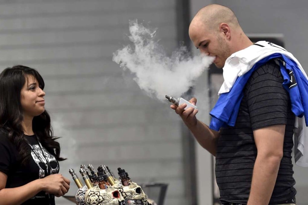 A man sampling a vape flavour supplied by a vendor. Photo: Reuters