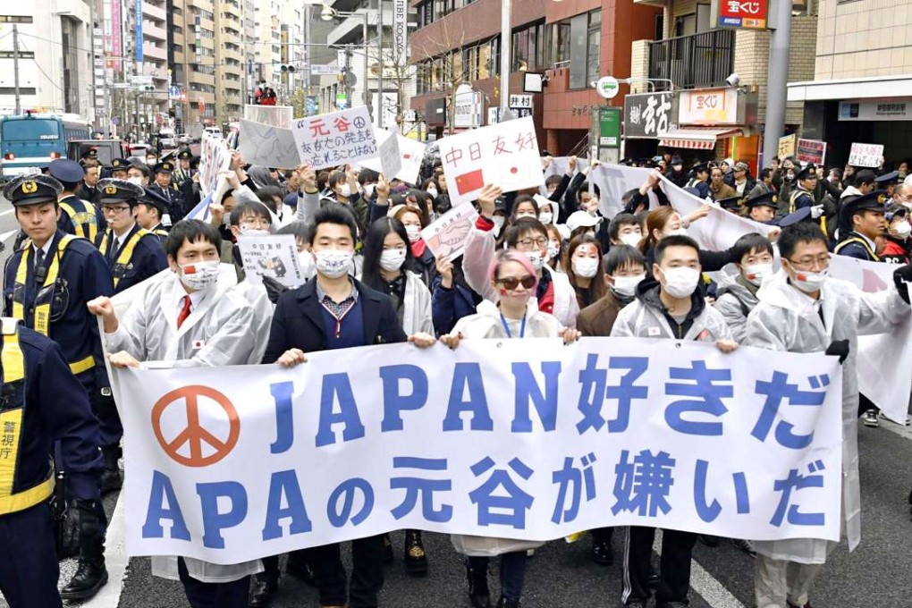 Chinese residents in Japan march at a protest against the Japanese hotel chain APA in Tokyo with placard reading, ' We like Japan, We dislike Motoya.” Photo: Kyodo/via Reuters