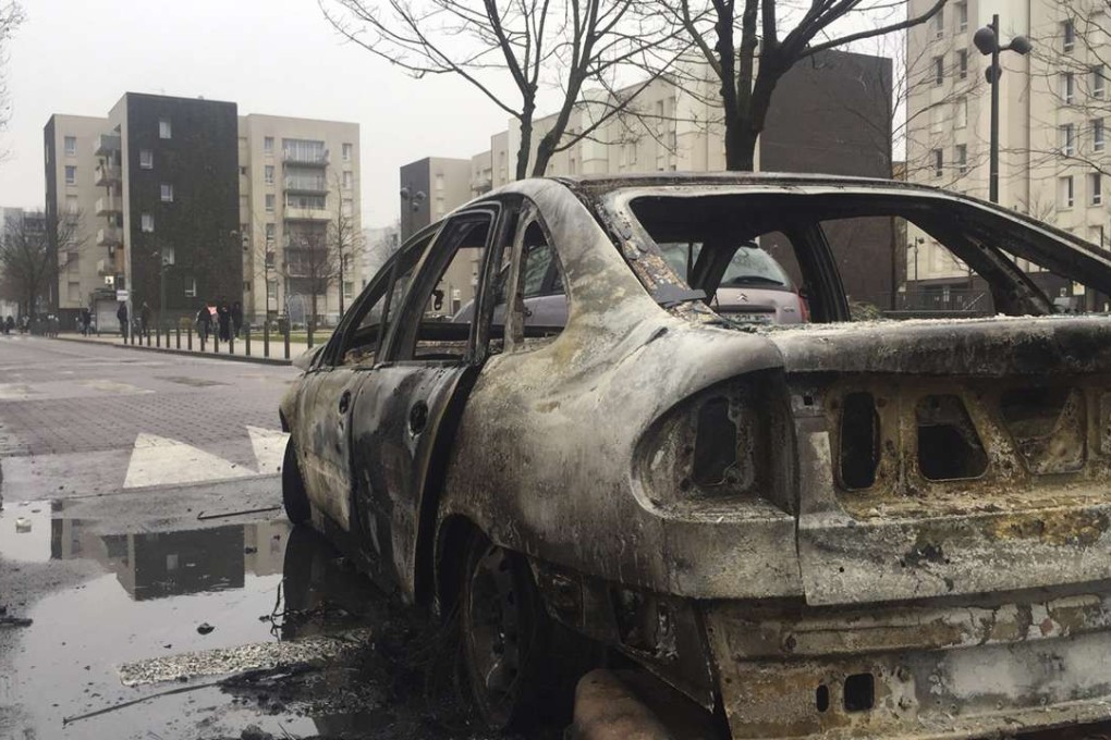 The remains of a car burnt by protesters is seen in Aulnay-sous-Bois, north of Paris. Photo: AP