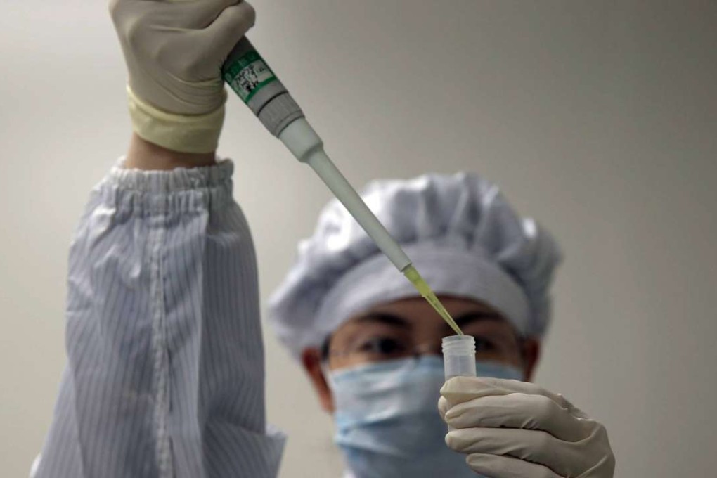 A woman works at a biotechnology company in Shanghai that produces bird flu reagent kits used to identify those with the virus. Photo: EPA