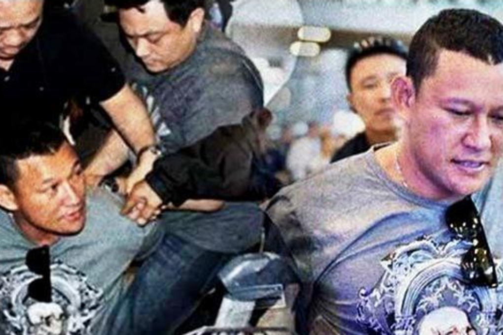 Lao national Xaysana Keopimpha was literally taken down (left) and arrested at Suvarnabhumi airport on January 19, and police have released no details of his interrogations.