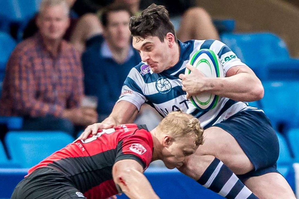 Charlie Higson-Smith is tackled by Max Woodward while playing for Hong Kong Football Club. Photos: HKRU