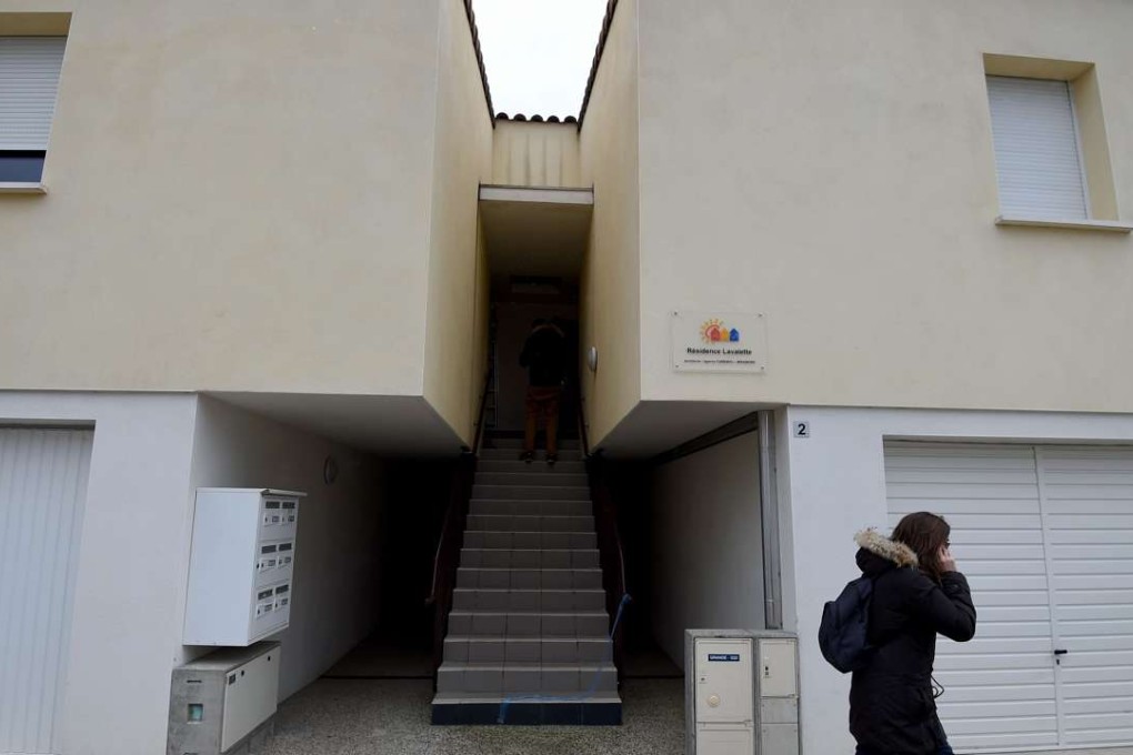 A woman walks in front of an apartment building in Clapiers where suspects believed to be involved in plotting an attack were arrested by French anti-terrorist police. Photo: AFP