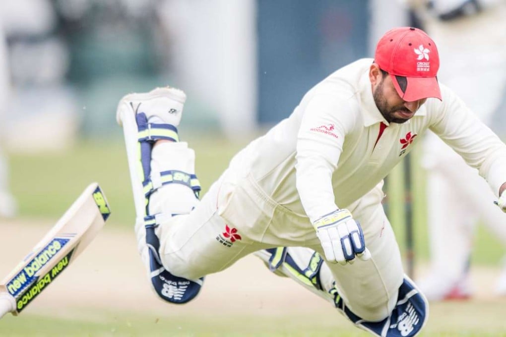 Hong Kong captain Babar Hayat dives for the crease while chasing a run. Photo: Panda Man