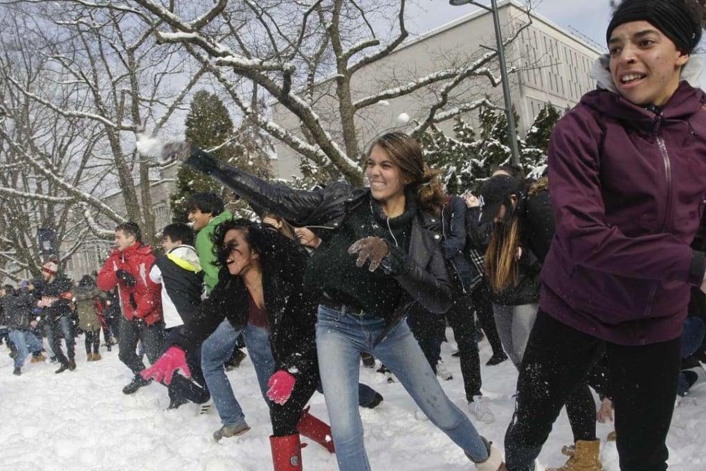 Students take part in a mass snowball fight at the University of British Columbia in Vancouver on Monday. Students made up about 5 per cent of buyers in a study of multi-million-dollar home sales in Vancouver. Photo: Xinhua