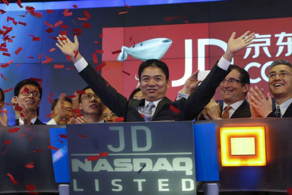 Richard Liu, CEO and founder of JD.com, raises his hands after the opening bell of Nasdaq in New York in this May 22, 2014 file photo. Liu wants to expand the company into online insurance and finance. Photo: Reuters