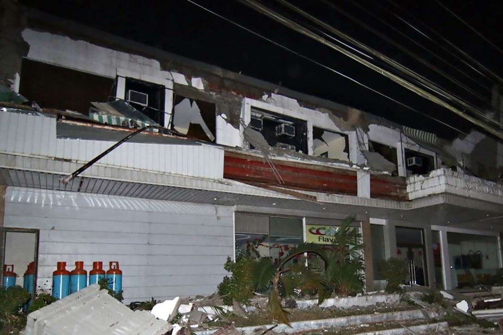 Debris litter next to a destroyed hotel after a 6.5-magnitude earthquake struck overnight in Surigao City, in the southern Philippine island of Mindanao. Photo: AFP