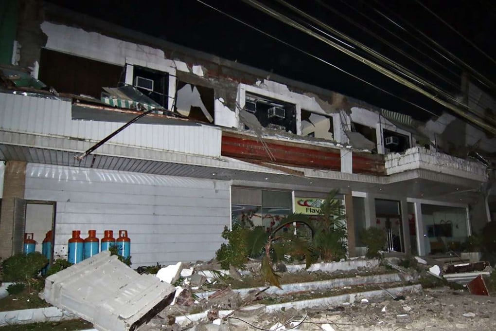 Debris litter next to a destroyed hotel after a 6.5-magnitude earthquake struck overnight in Surigao City. Photo; AFP